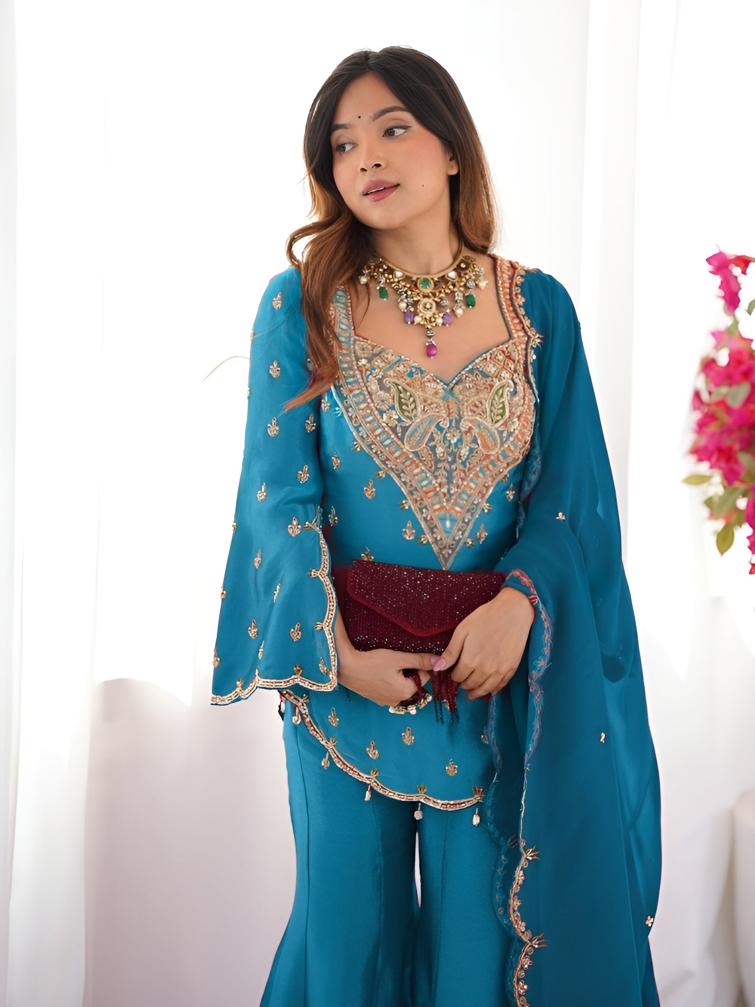 Girl Wearing turquoise-blue Ananya Shimmer Silk Palazzo Suit with Embroidery and Dupatta in her house