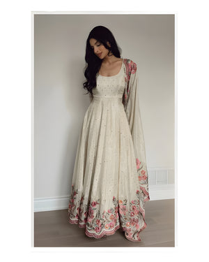 Woman wearing a floral dress with a plain background