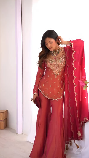 Girl Wearing pink Ananya Shimmer Silk Palazzo Suit with Embroidery and Dupatta in her house