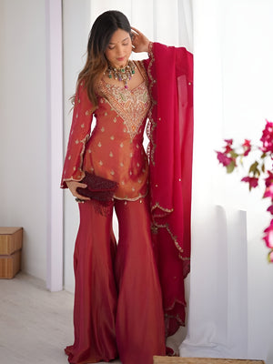 Girl Wearing pink Ananya Shimmer Silk Palazzo Suit with Embroidery and Dupatta in her house