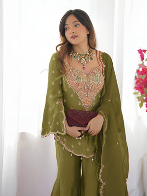 Girl Wearing Olive green Ananya Shimmer Silk Palazzo Suit with Embroidery and Dupatta in her house