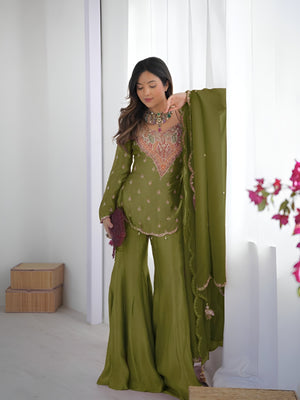 Girl Wearing Olive green Ananya Shimmer Silk Palazzo Suit with Embroidery and Dupatta in her house