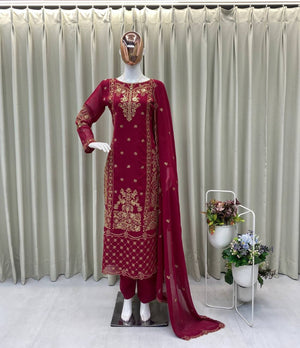 wine embroidered traditional outfit on a mannequin with a neutral background